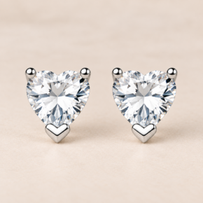 Front-facing pair of sterling silver 8mm heart CZ stud earrings with polished silver settings.