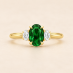 9ct yellow gold lab-grown emerald and diamond three-stone ring, front view