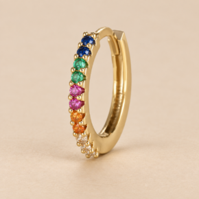 Detail of multicoloured cubic zirconia and gold prong settings on a 14ct gold-plated sterling silver hoop earring