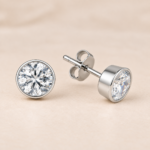 Pair of 7mm sterling silver round CZ rub-over stud earrings, showing the bezel setting, post and butterfly back.