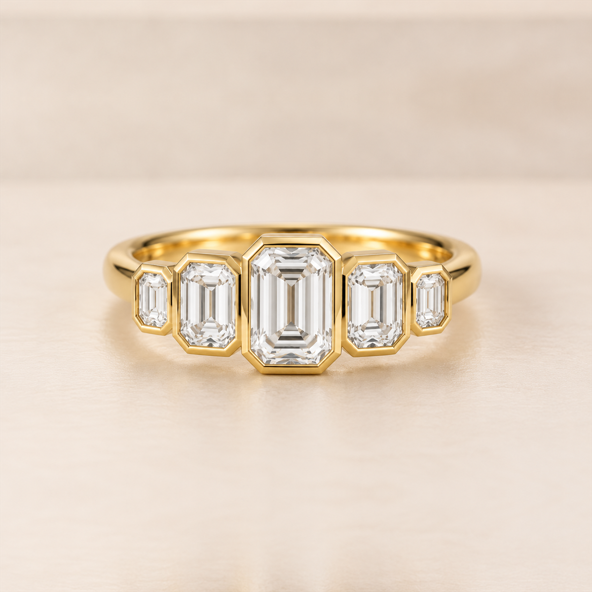 Emerald Cut Lab-Grown Diamond Five-Stone Ring Front View Front view of five graduated emerald-cut lab-grown diamonds in yellow-gold rub-over settings