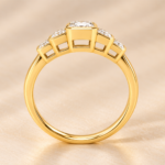 Side view of yellow gold five-stone emerald-cut lab-grown diamond ring with rub-over settings