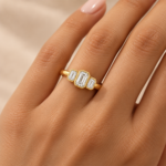 9ct yellow gold emerald-cut lab-grown diamond three-stone ring worn on the hand
