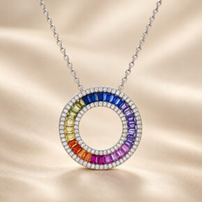 London Facets multi-coloured CZ Circle of Life necklace in rhodium-plated sterling silver, front view on champagne fabric