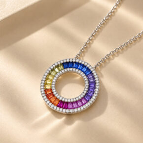 London Facets multi-coloured CZ Circle of Life necklace arranged diagonally on soft champagne fabric