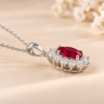 Profile view of a 9ct white gold lab-grown ruby and diamond halo necklace