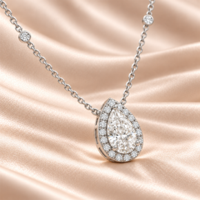Angled view of a 9ct white gold pear lab-grown diamond halo necklace with diamond-set chain stations