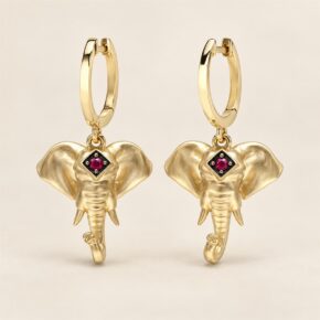 Pair of 9ct yellow gold ruby elephant head drop earrings, front view.