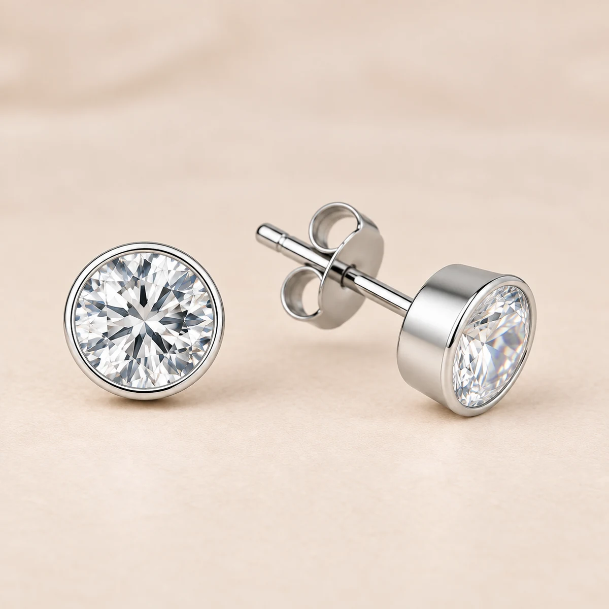 Sterling silver round CZ rub-over stud earrings showing bezel settings, post and butterfly back